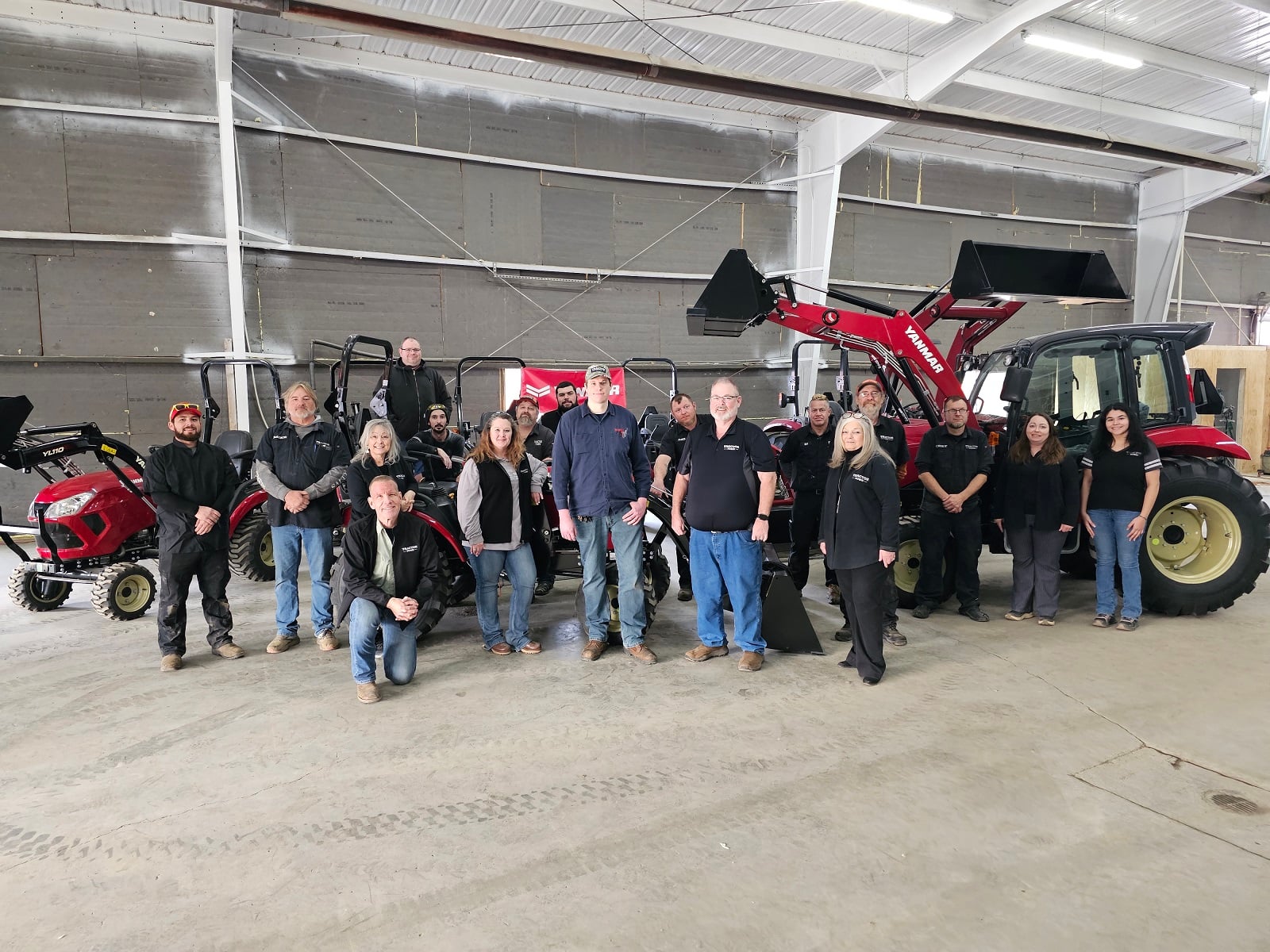 Photo of multiple customoers standing infront of YanmarEQuipment